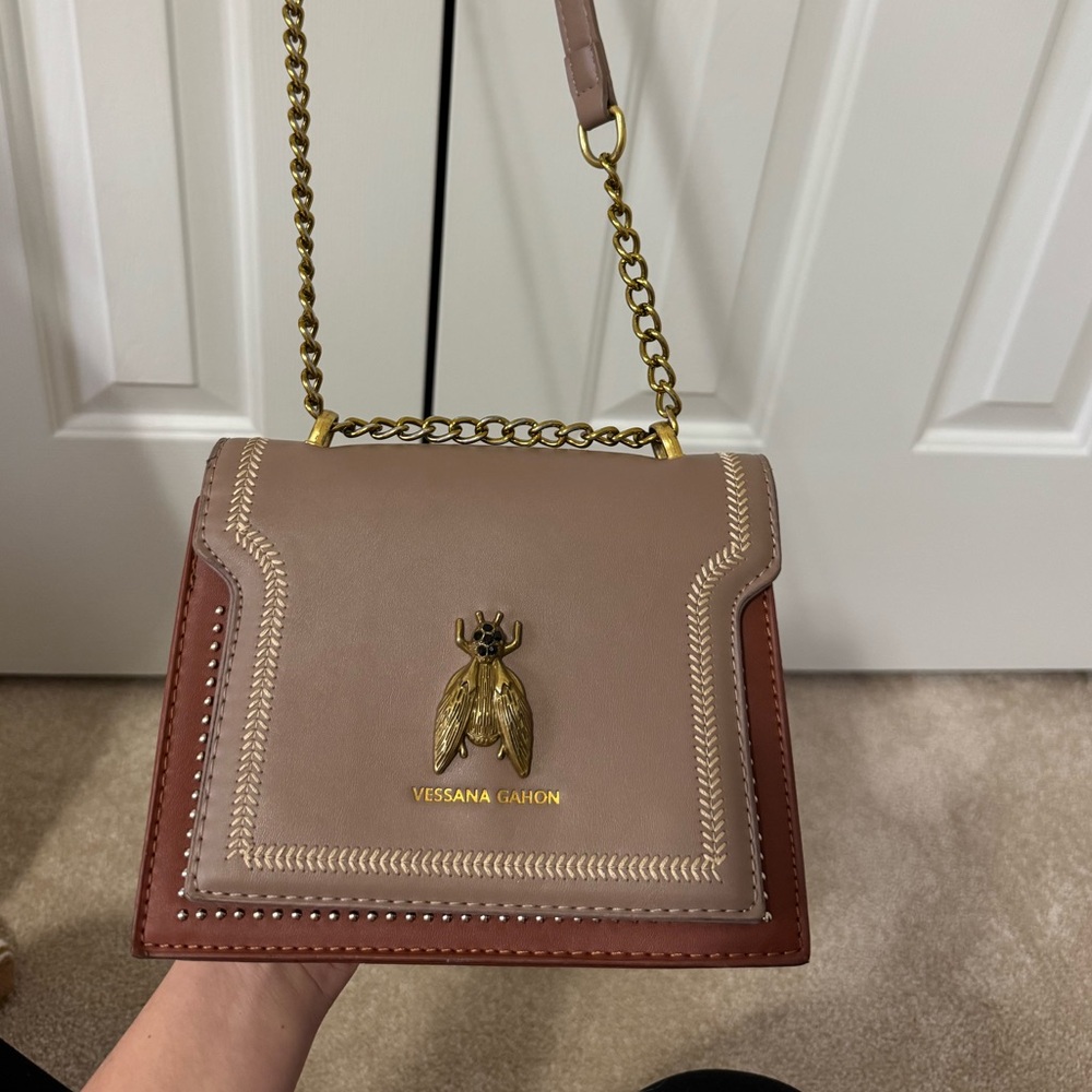 Brown and tan Vessana Gahon crossbody bag with gold accents #crossbodybag